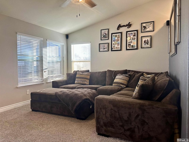 carpeted living room featuring lofted ceiling, a ceiling fan, and baseboards