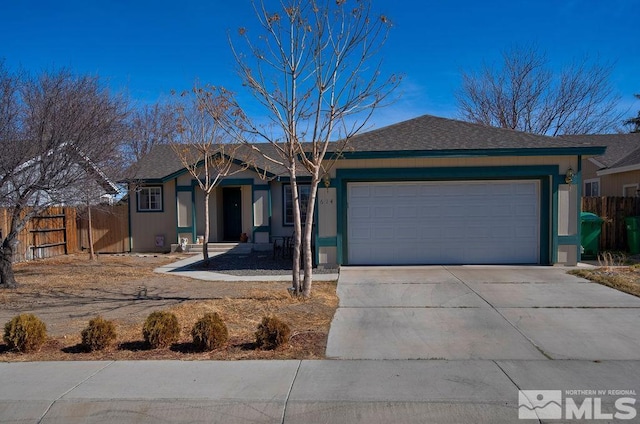 single story home featuring an attached garage, fence, and concrete driveway