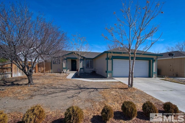 ranch-style home featuring concrete driveway, fence, an attached garage, and stucco siding