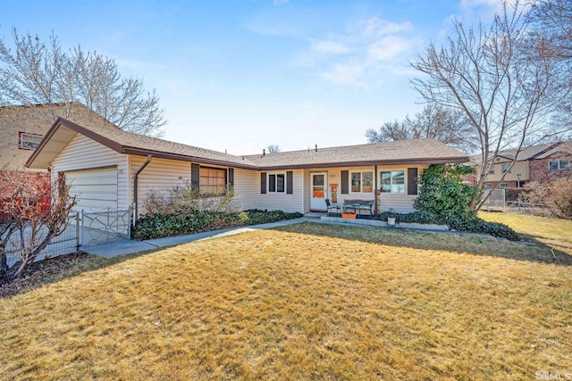 single story home featuring a garage, fence, and a front lawn