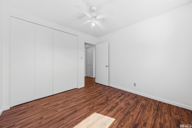 unfurnished bedroom with a ceiling fan, baseboards, a closet, and wood finished floors