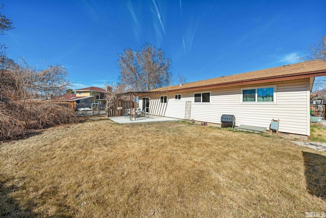 rear view of property featuring a yard and a patio