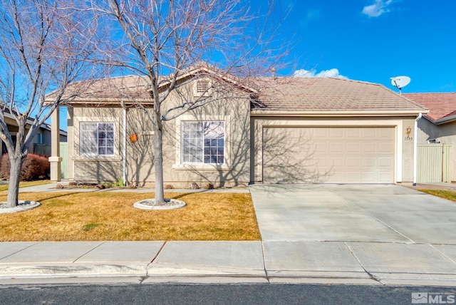 single story home with a garage, fence, concrete driveway, stucco siding, and a front yard