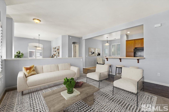 living area featuring wood finished floors and baseboards