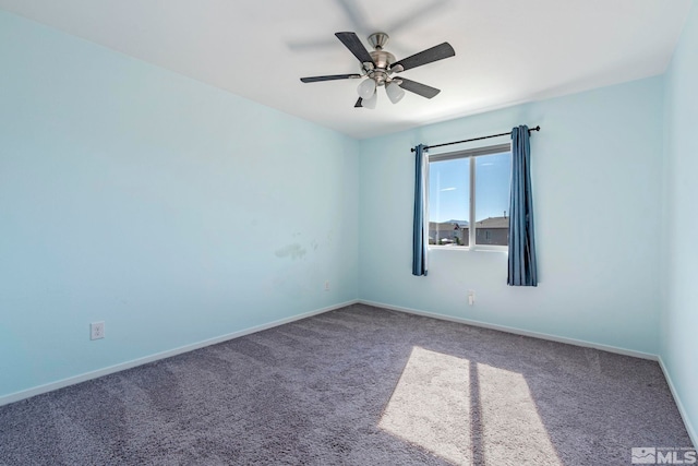 carpeted empty room with ceiling fan and baseboards