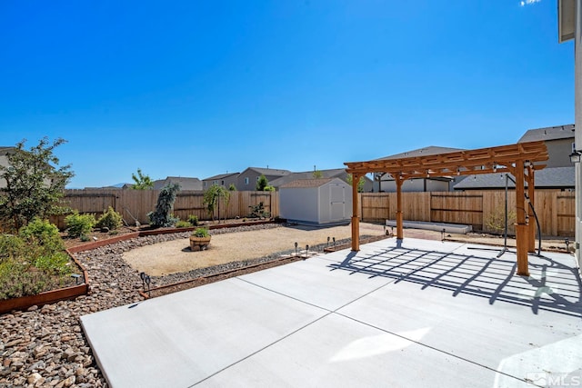 view of patio / terrace with an outbuilding, a vegetable garden, a shed, a pergola, and a fenced backyard