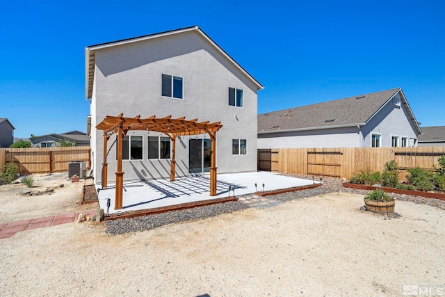 rear view of house featuring stucco siding, central AC unit, a patio area, a pergola, and a fenced backyard