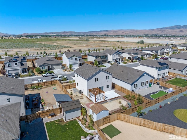 birds eye view of property with a mountain view and a residential view