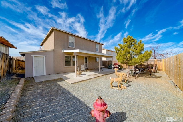 back of house featuring stucco siding, a fenced backyard, and a patio