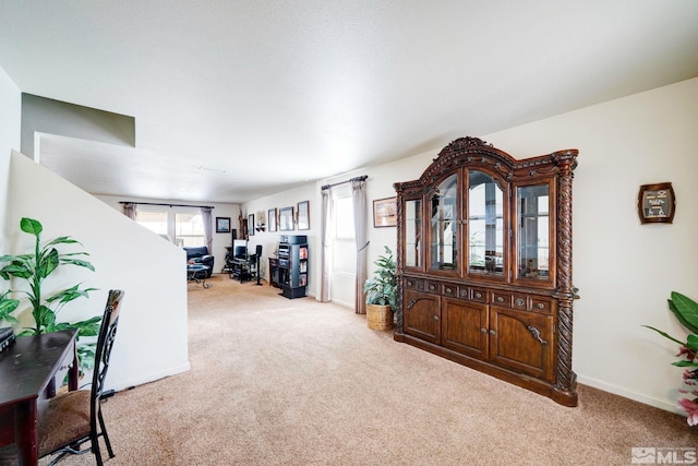 interior space with carpet floors and baseboards