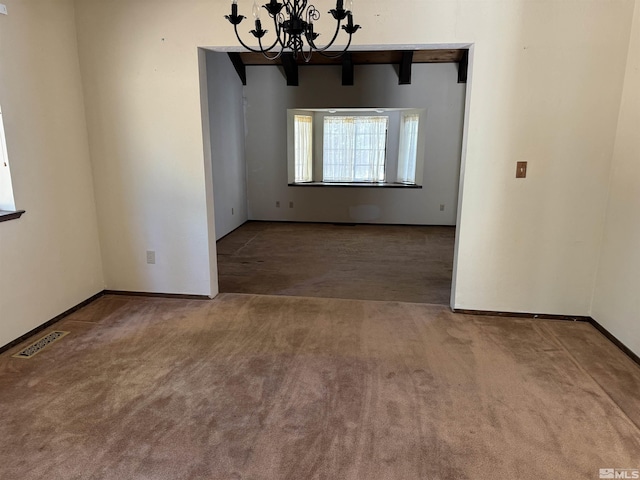 unfurnished dining area featuring visible vents, an inviting chandelier, carpet flooring, beamed ceiling, and baseboards