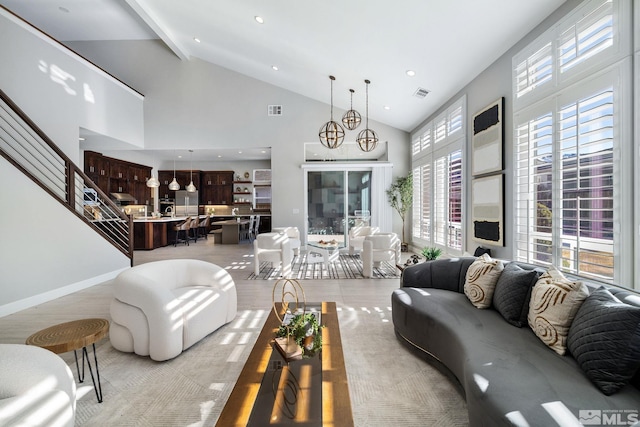 living room with high vaulted ceiling, visible vents, baseboards, stairs, and beam ceiling