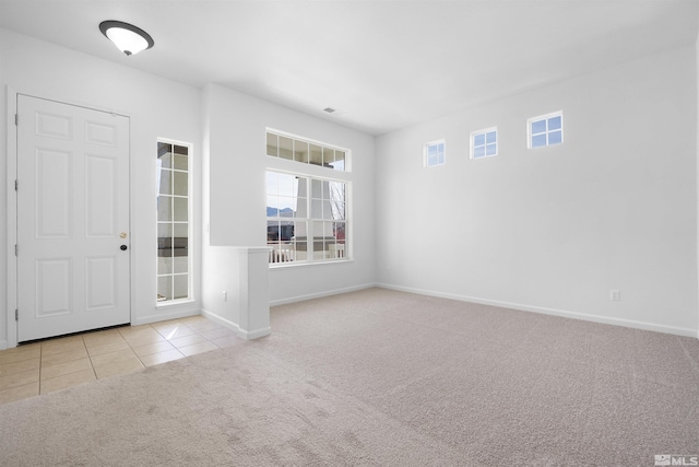 tiled foyer entrance featuring carpet, visible vents, and baseboards