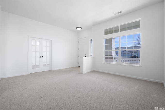 unfurnished bedroom featuring carpet, french doors, visible vents, and baseboards