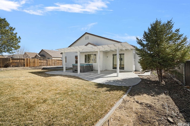 rear view of house featuring a hot tub, a patio, a fenced backyard, a yard, and a pergola