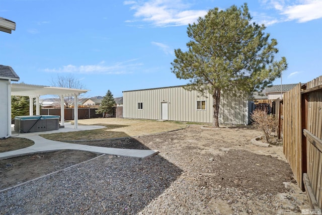 view of yard with a hot tub, a pergola, a fenced backyard, and a patio