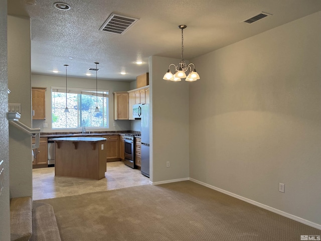 kitchen featuring visible vents, a center island, appliances with stainless steel finishes, and light colored carpet