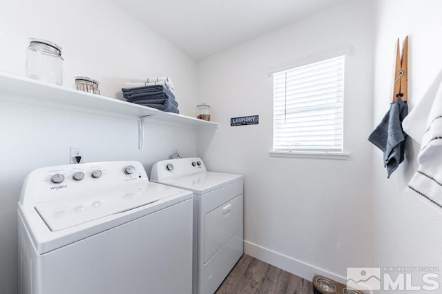 laundry area with dark wood-style floors, laundry area, washing machine and clothes dryer, and baseboards