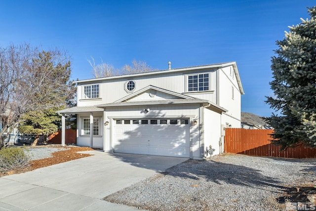 traditional-style house with a garage, fence, and concrete driveway