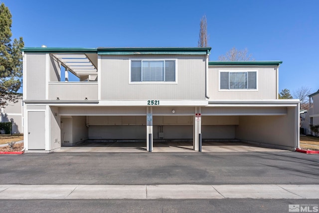 view of front of house featuring covered parking