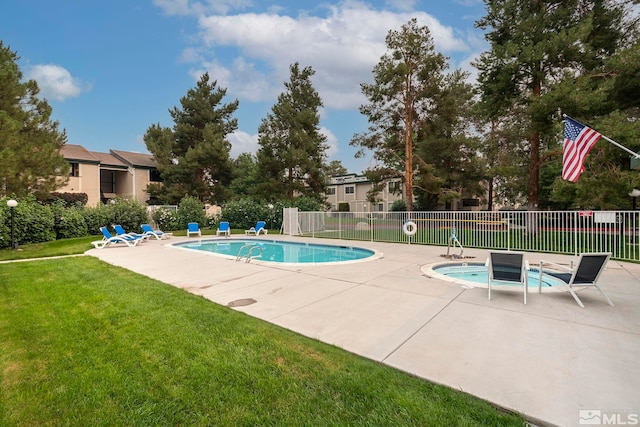 pool with fence, a lawn, and a patio