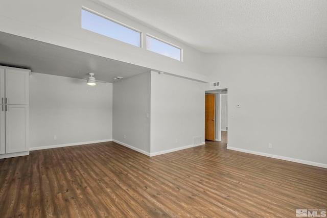 spare room featuring a textured ceiling, wood finished floors, a ceiling fan, and baseboards