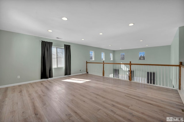 unfurnished room featuring recessed lighting, visible vents, baseboards, and wood finished floors