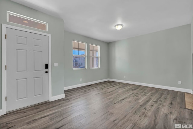 entrance foyer with baseboards and wood finished floors