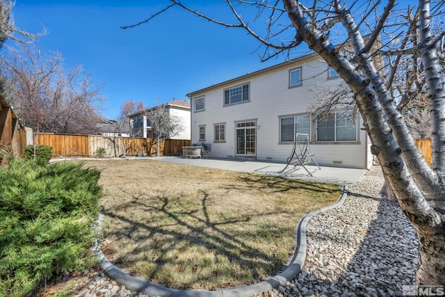 back of property featuring crawl space, a fenced backyard, a lawn, and a patio