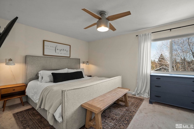 bedroom with light carpet and a ceiling fan