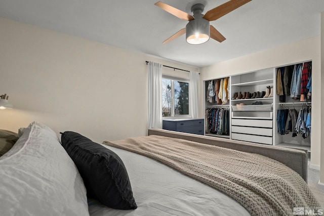 carpeted bedroom with a closet and ceiling fan