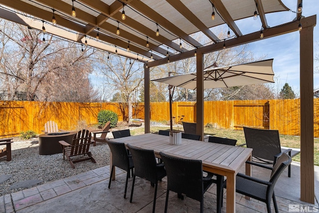 view of patio featuring an outdoor fire pit, a fenced backyard, a pergola, and outdoor dining space