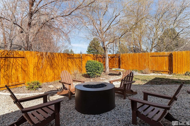 view of patio / terrace with a fire pit and fence