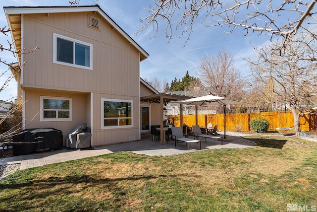 back of house with a yard, a patio, and fence