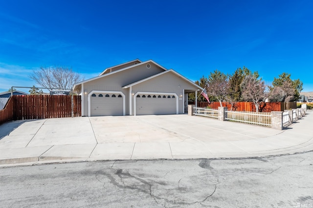 view of home's exterior featuring driveway, a fenced front yard, and an attached garage