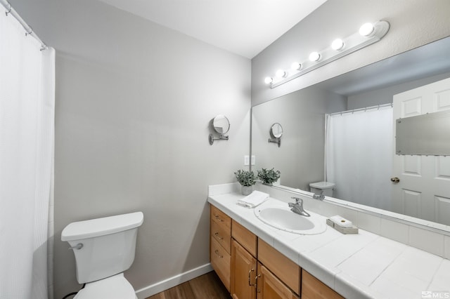 full bath featuring wood finished floors, vanity, toilet, and baseboards