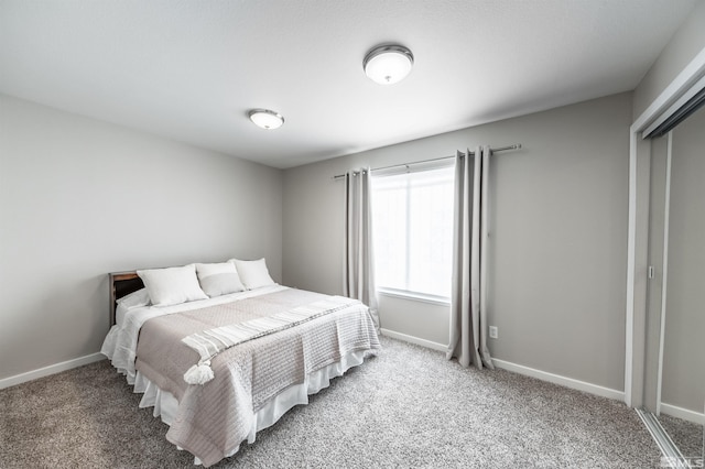 carpeted bedroom with baseboards