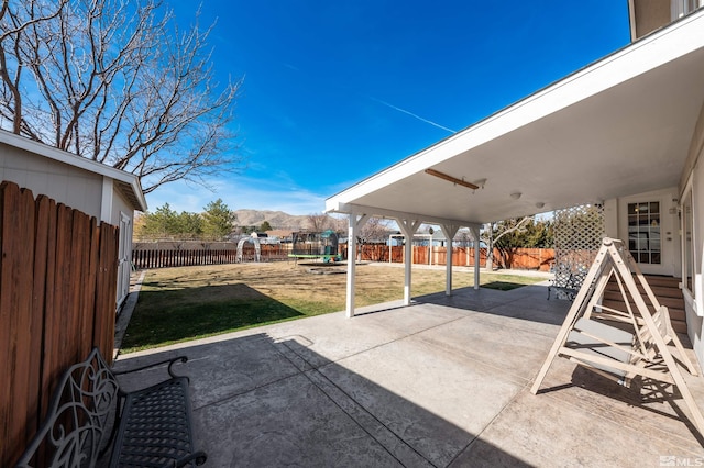 view of patio / terrace featuring a fenced backyard and a mountain view