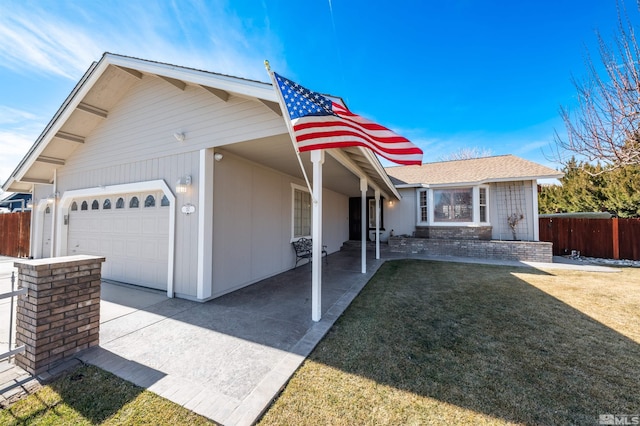 view of front of home with a garage, fence, a front lawn, and concrete driveway