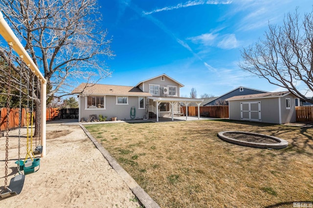 rear view of property with an outbuilding, a patio area, and a fenced backyard