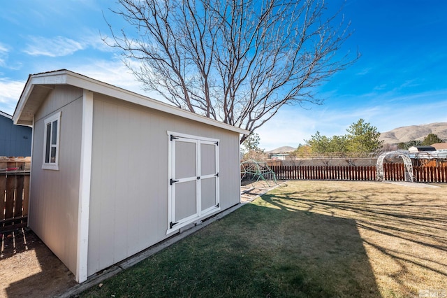 view of shed featuring fence private yard and a mountain view