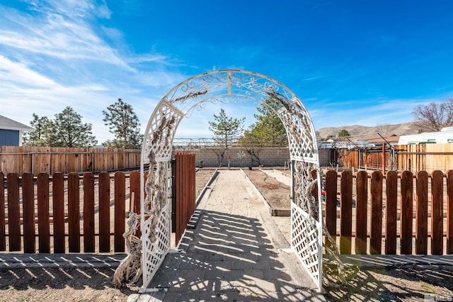 view of gate featuring a fenced backyard