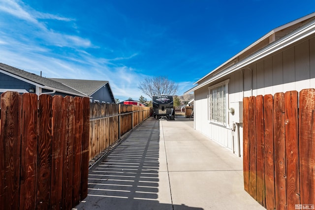 view of side of property featuring a patio area and fence