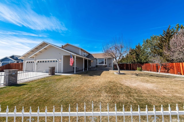 view of front of home featuring an attached garage, fence private yard, and a front yard