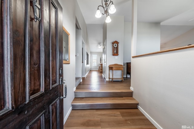 entryway featuring baseboards and wood finished floors