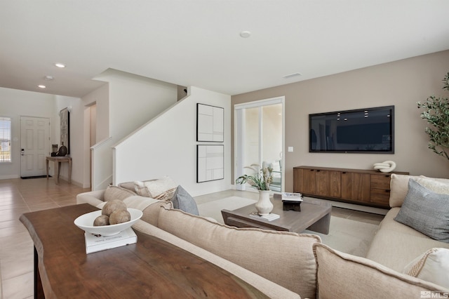 living area with visible vents, light tile patterned flooring, stairway, and recessed lighting