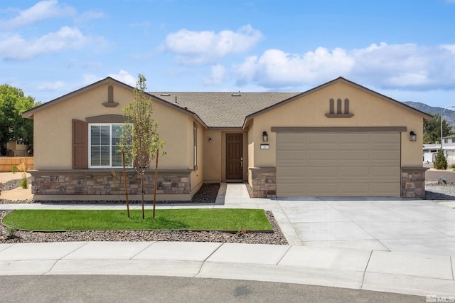 ranch-style house with a shingled roof, concrete driveway, stone siding, an attached garage, and stucco siding