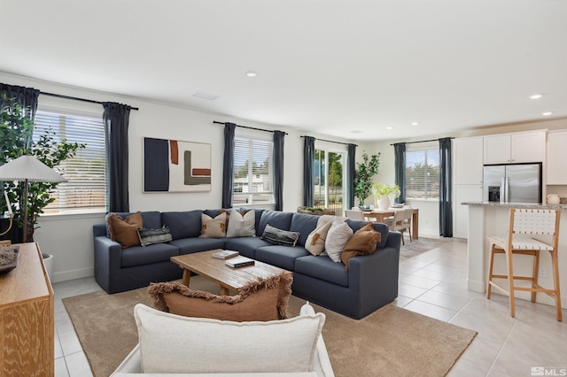 living area with light tile patterned floors, baseboards, and recessed lighting