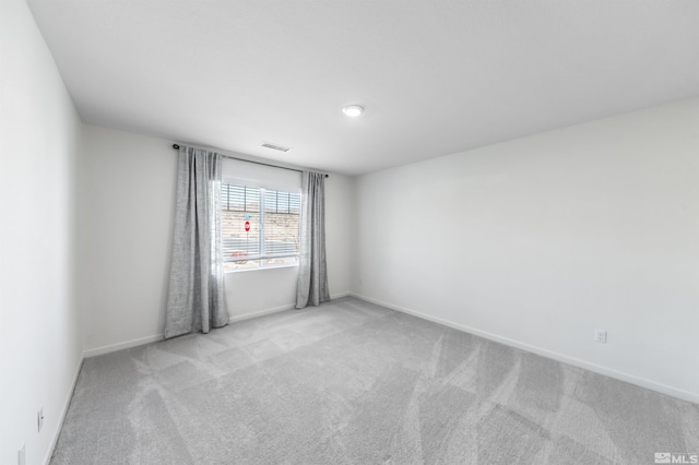 empty room featuring carpet floors and baseboards