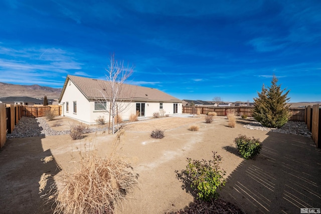 back of house featuring a patio area, a fenced backyard, and stucco siding